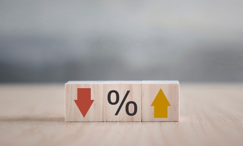 Three wooden blocks each with an upward arrow, percentage sign and downward arrow representing the statistical information that reflect likely prevalence of toxic stress and trauma.