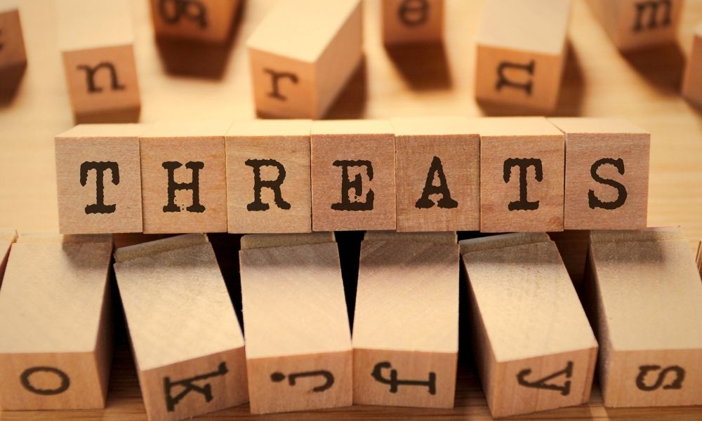 Wooden block letters spelling the word "treat" signifying the various types of harm that can result in toxic stress and trauma.