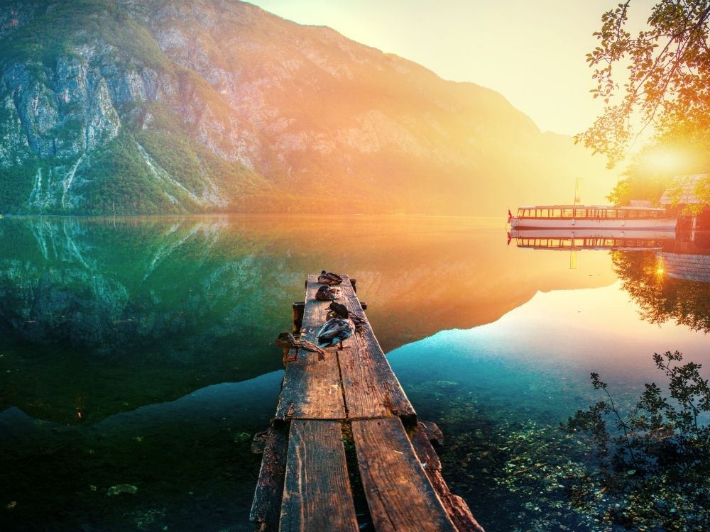 A beautiful water and mountain landscape in many muted colours.