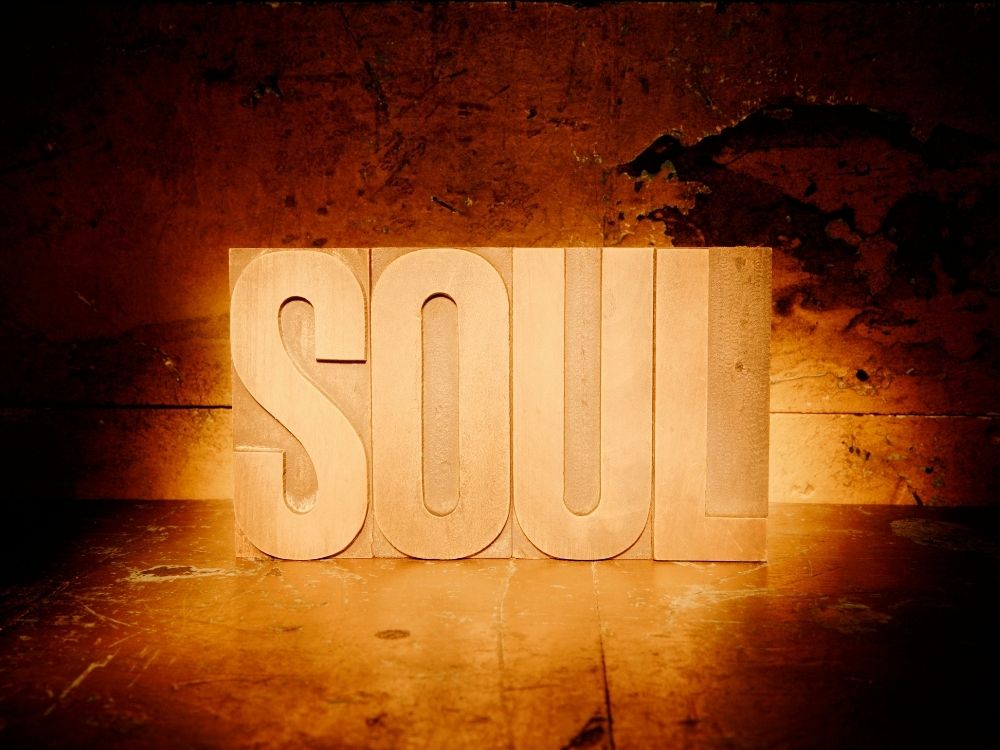 The word "SOUL" in larger wooden block letters against a rustic background.